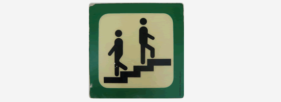 An exit sign with two people walking up and down some stairs - rejection.