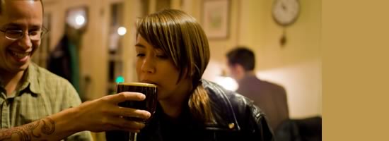 A girl drinking a beer.